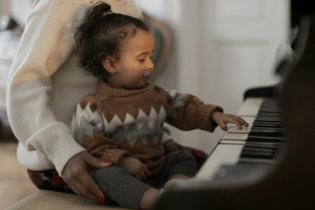 girl-in-brown-sweater-playing-piano